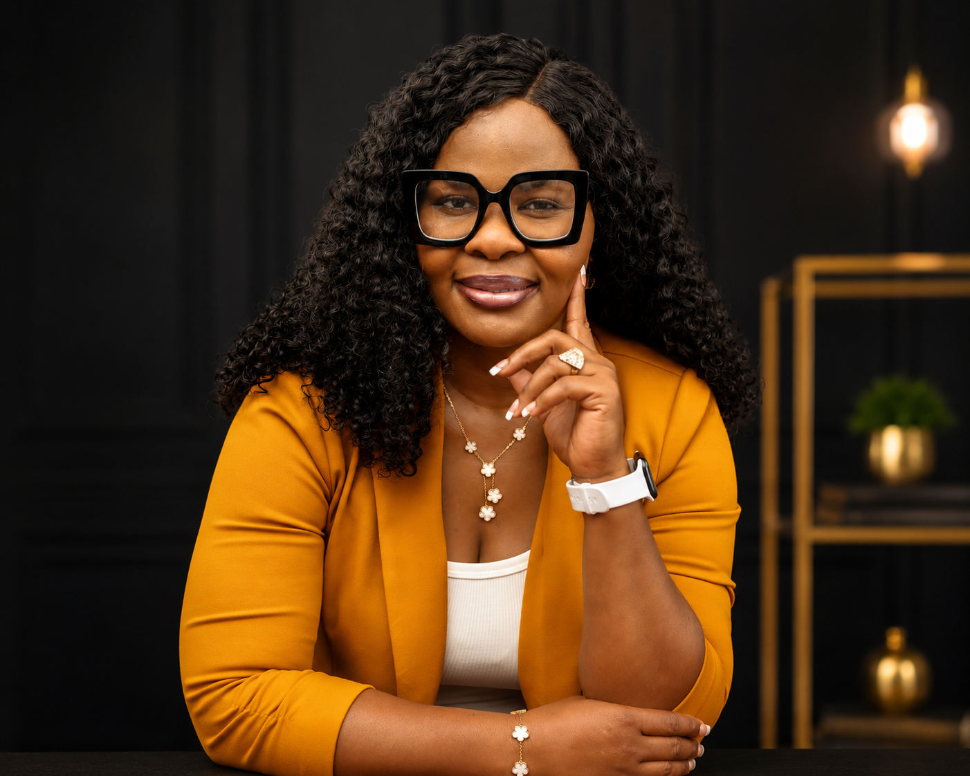 Dr. Tessy Aguzie, The Resilience Architect™, in a mustard blazer